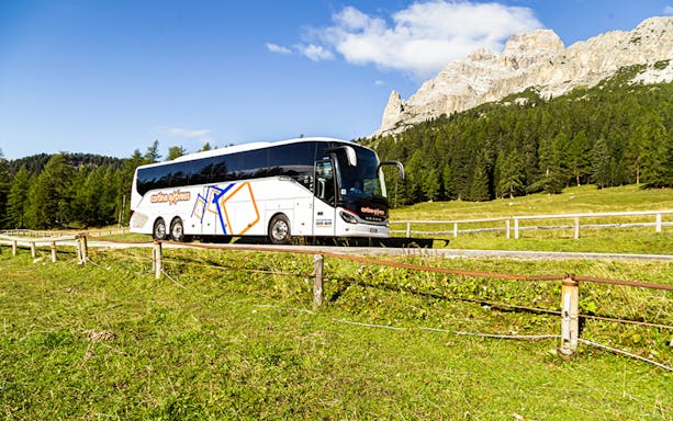 Venice airport transfer bus driving through scenic countryside.