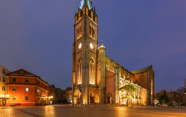 Myeongdong Cathedral illuminated at night during Seoul Night Guided Tour.