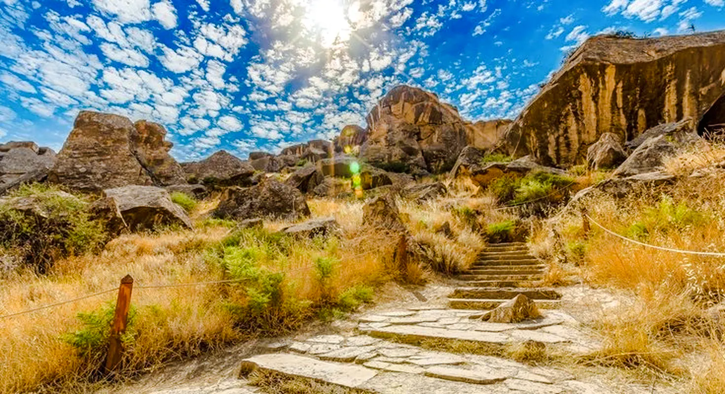 Gobustan rock formations under a bright sky, part of the Full Day Gobustan & Absheron Tour, Baku.