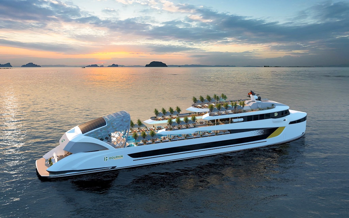 Luxury cruise ship on calm waters at sunset in Halong Bay.