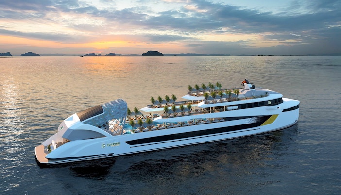 Luxury cruise ship on calm waters at sunset in Halong Bay.