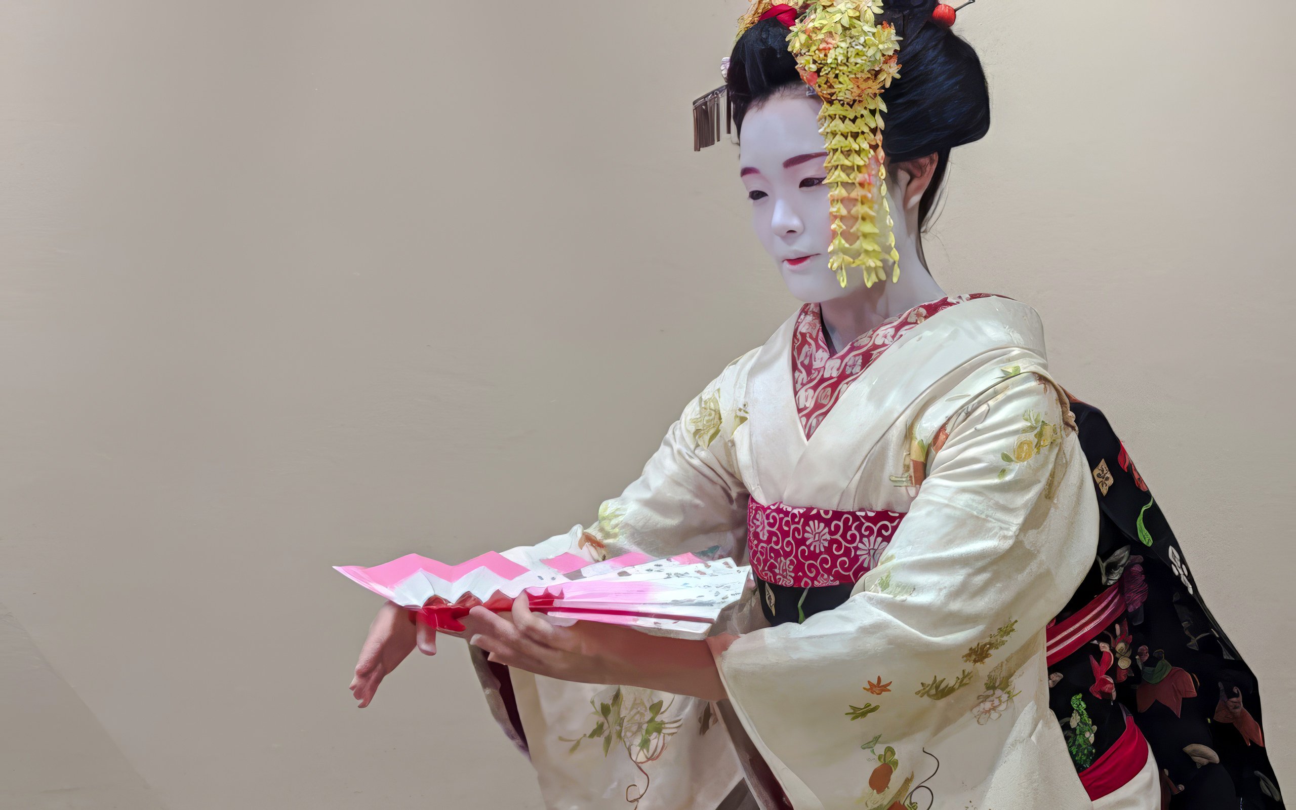 Maiko in traditional kimono performing with a fan in Kyoto, Japan.