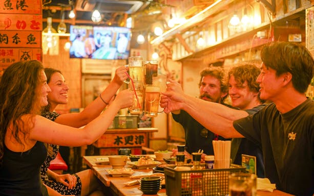 Tourists enjoying drinks at a Shinjuku bar in Tokyo.