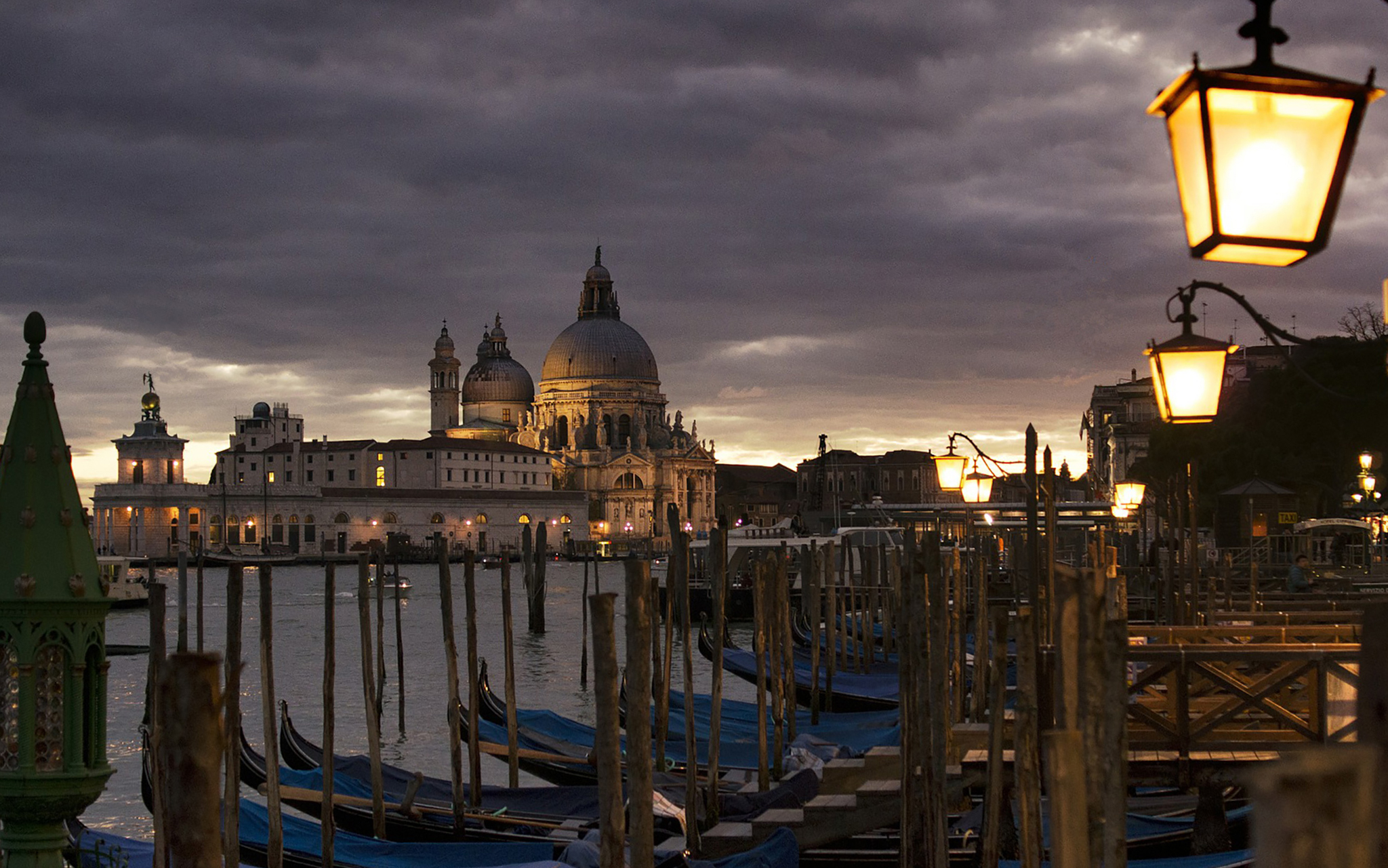 Venice Grand Canal at night with Santa Maria della Salute and gondolas.
