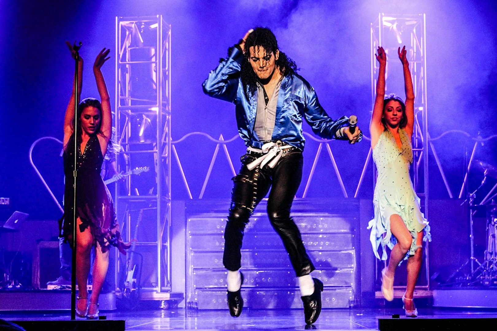 Performer in blue jacket dancing on stage during MJ Live show in Las Vegas.