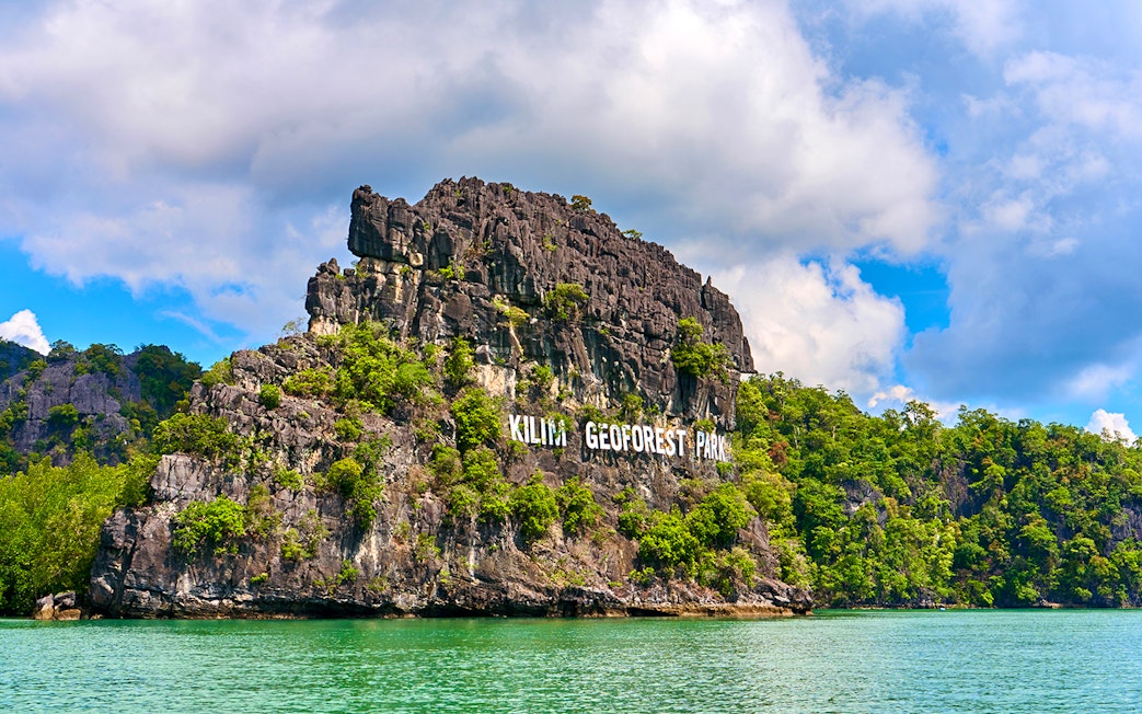 Kilim Geoforest Park limestone cliffs in Langkawi, Malaysia, viewed from the water.