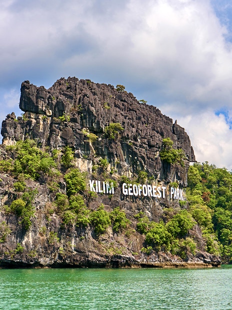 Kilim Geoforest Park limestone cliffs in Langkawi, Malaysia, viewed from the water.