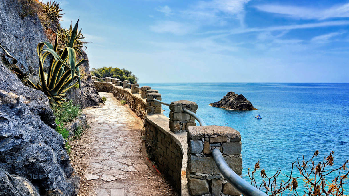 Stone path along the coast with sea view in Cinque Terre, Italy.