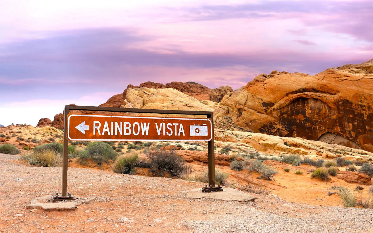 Rainbow Vista sign in Valley of Fire State Park, Nevada, with red rock formations.
