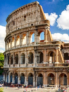 Colosseum in Rome with tourists exploring the ancient amphitheater.