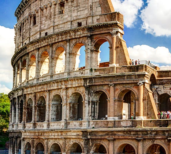Colosseum in Rome with tourists exploring the ancient amphitheater.