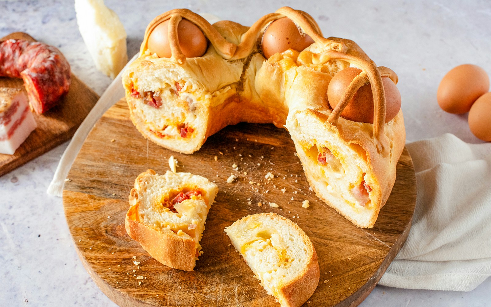 Casatiello Milanese bread with salami and cheese on a wooden board in Milan, Italy.