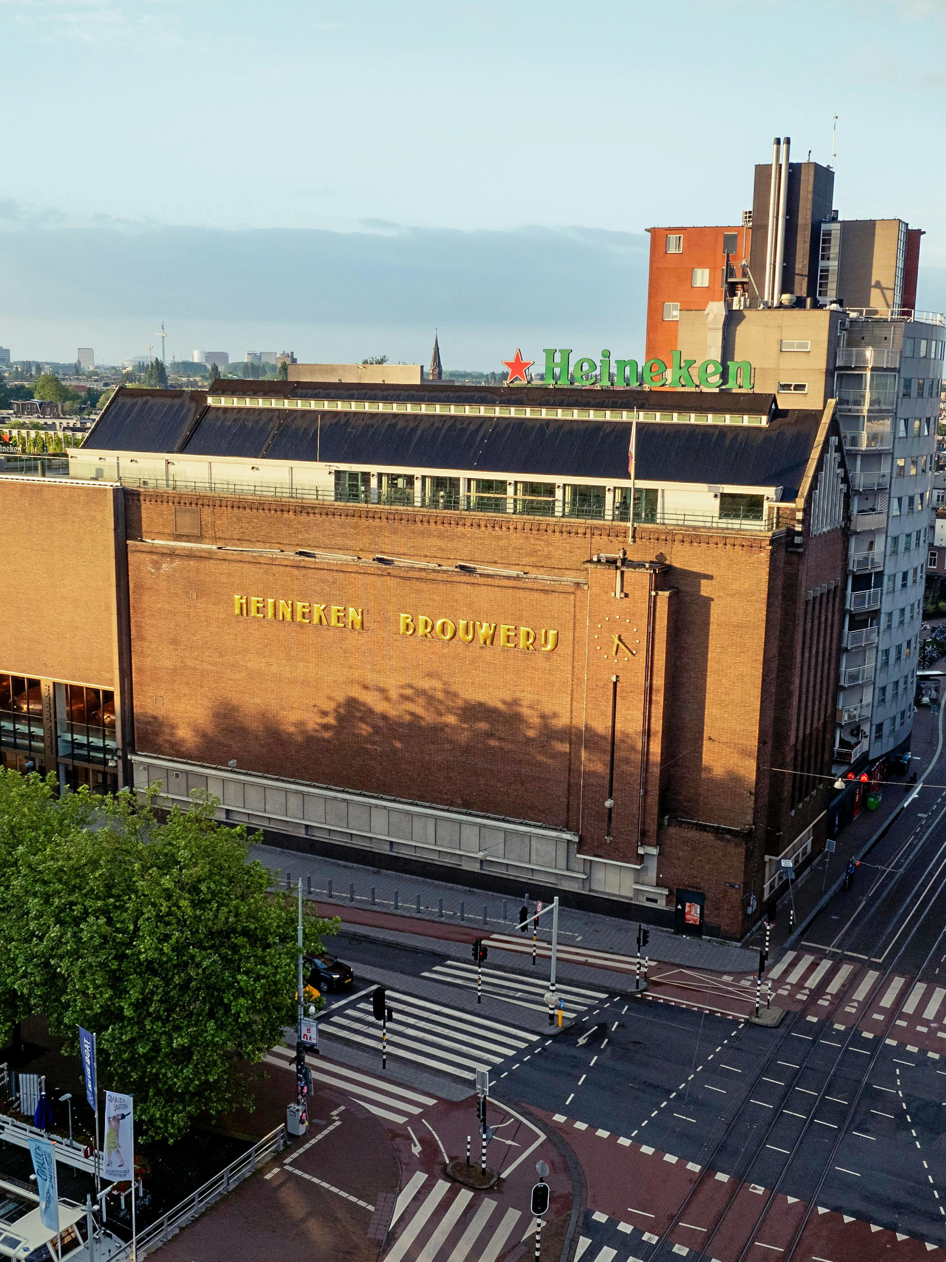 Heineken Brewery building in Amsterdam, view from above with cityscape.