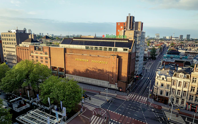 Heineken Brewery building in Amsterdam, view from above with cityscape.