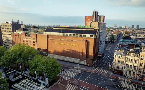 Heineken Brewery building in Amsterdam, view from above with cityscape.