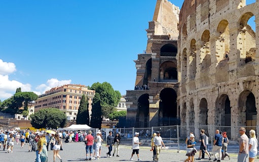Tour group at the Colosseum with Palatine Hill and Roman Forum in Rome, Italy.