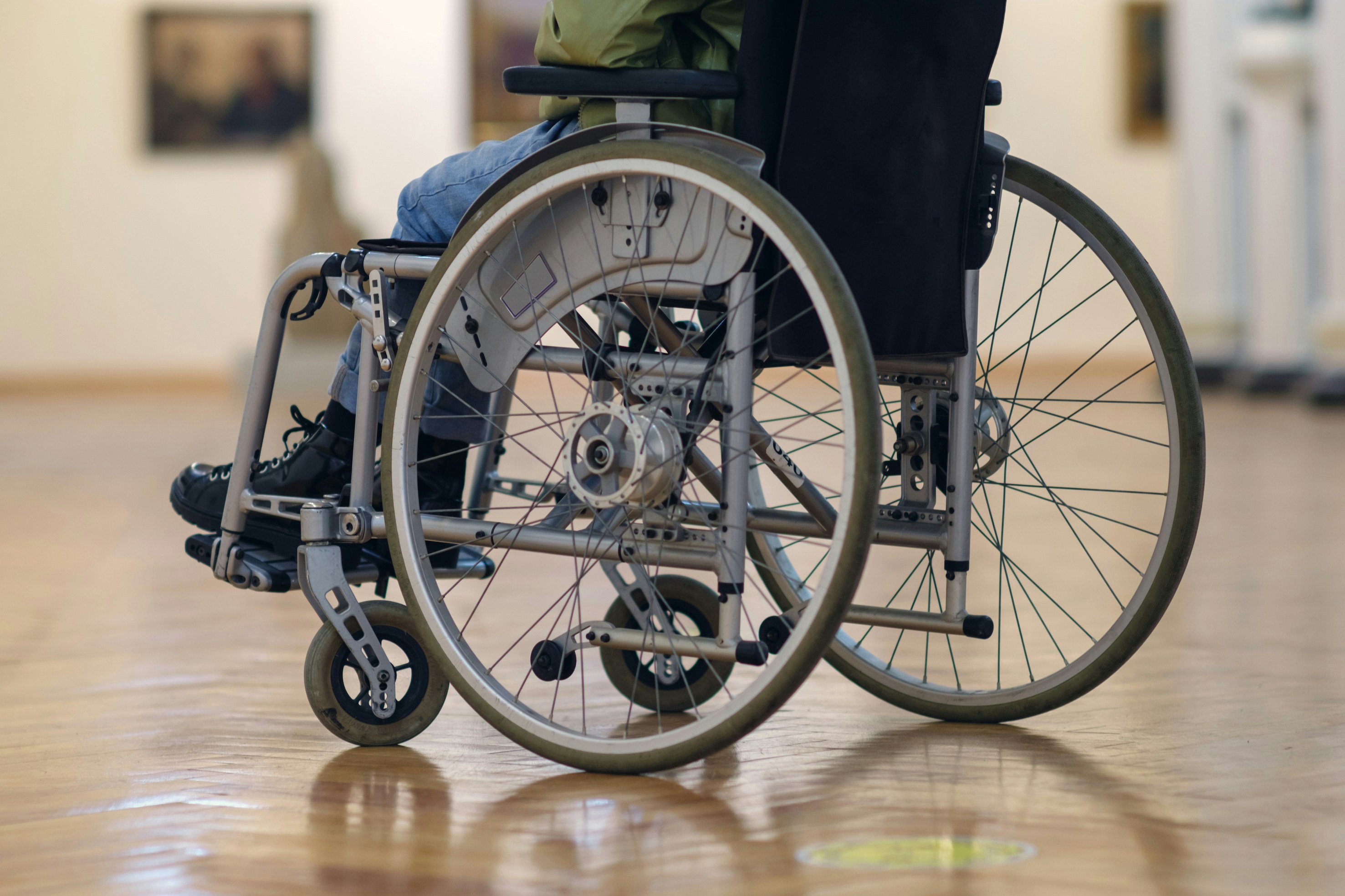Wheelchair user exploring an accessible museum gallery.