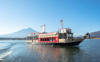 Cruise boat on Lake Kawaguchi with Mount Fuji in the background.