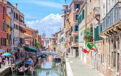 Venice canal with gondolas and colorful buildings on a walking tour route.