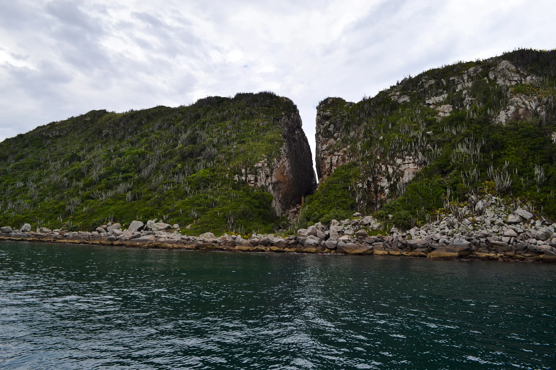 Coastal cliffs and clear water at Arraial do Cabo, Brazil.