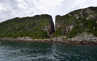 Coastal cliffs and clear water at Arraial do Cabo, Brazil.