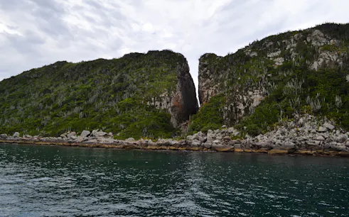 Coastal cliffs and clear water at Arraial do Cabo, Brazil.