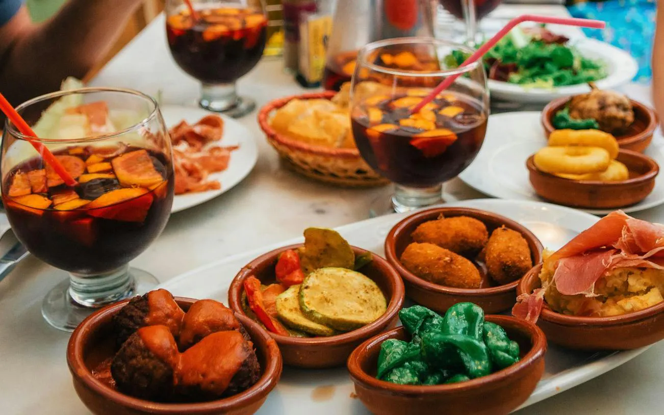 Tapas and sangria on a table during Valencia paella-making class with market visit.