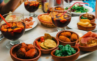 Tapas and sangria on a table during Valencia paella-making class with market visit.