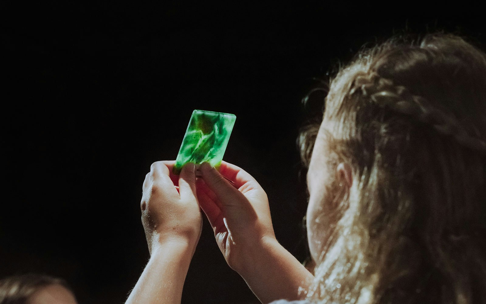 Person examining a piece of jade during the Mountain Jade Highlights Tour.