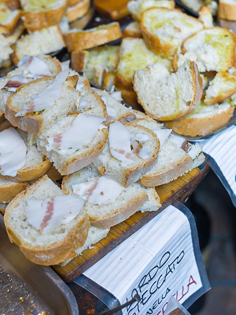 Slices of bread with various toppings on a guided food tour in Florence.