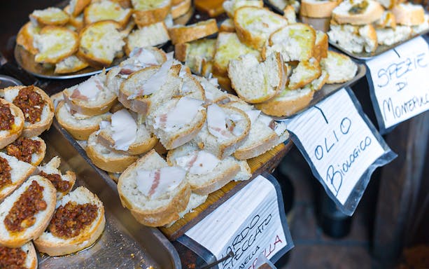 Slices of bread with various toppings on a guided food tour in Florence.