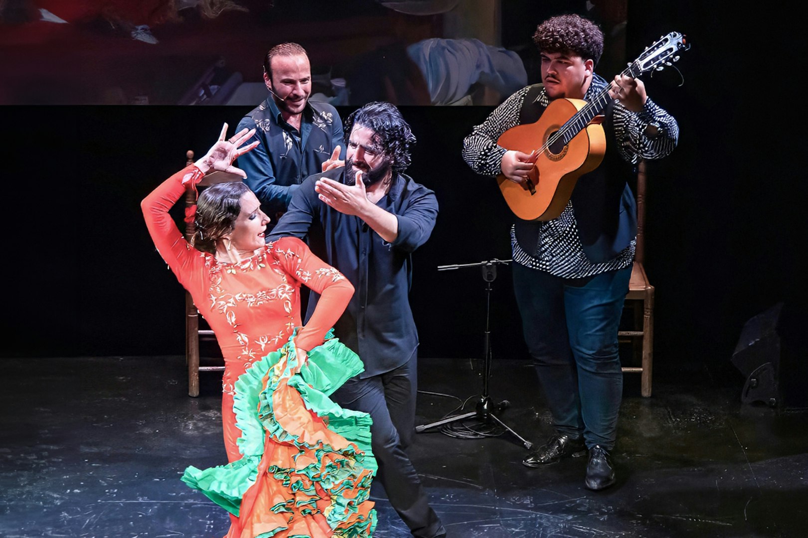 Flamenco dancers and guitarist performing at Teatro Flamenco Triana.