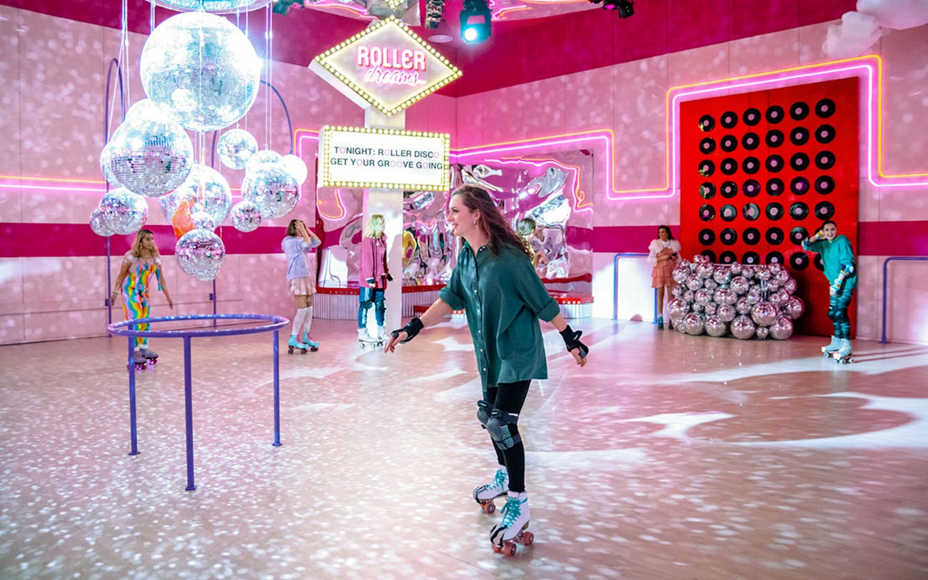 Roller skaters enjoying vibrant disco-themed rink in Amsterdam.