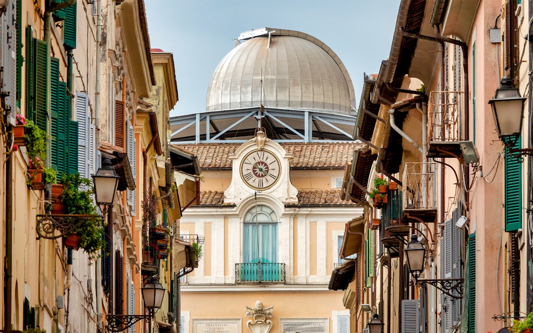 Vatican Observatory dome viewed from a narrow street in Castel Gandolfo, Italy.
