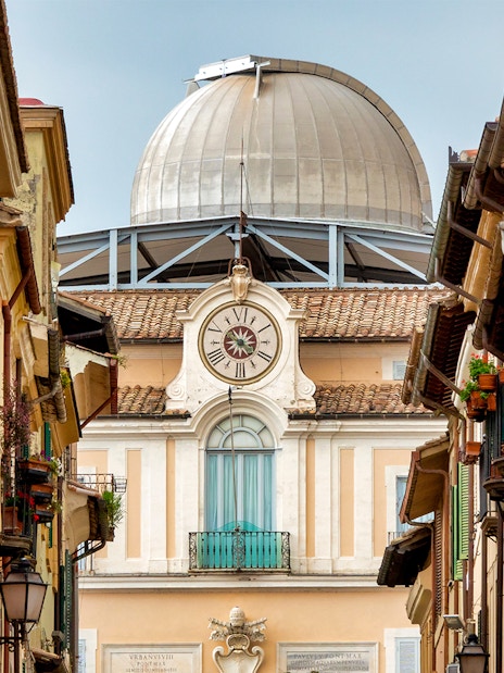 Vatican Observatory dome viewed from a narrow street in Castel Gandolfo, Italy.