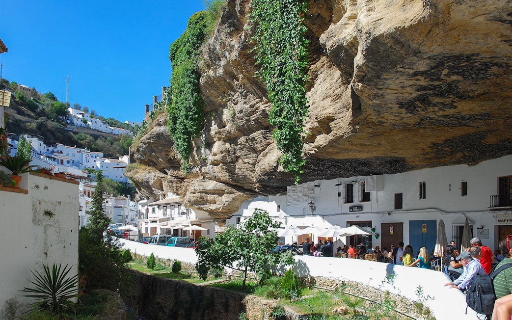 Setenil de las Bodegas street with houses built into rock overhang, Spain.