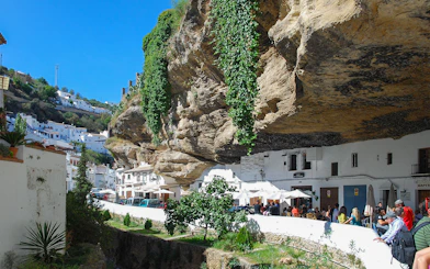 Setenil de las Bodegas street with houses built into rock overhang, Spain.