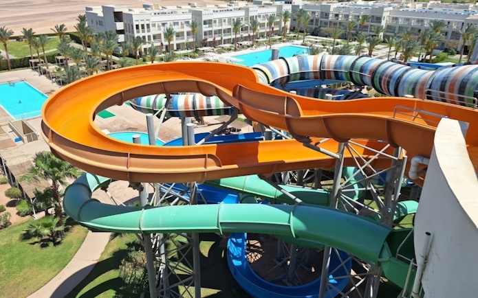 Water slides at Makadi Water World, Hurghada with colorful tubes and pools in the background.