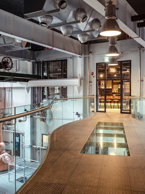 Roe & Co Distillery interior with copper stills and modern walkway.