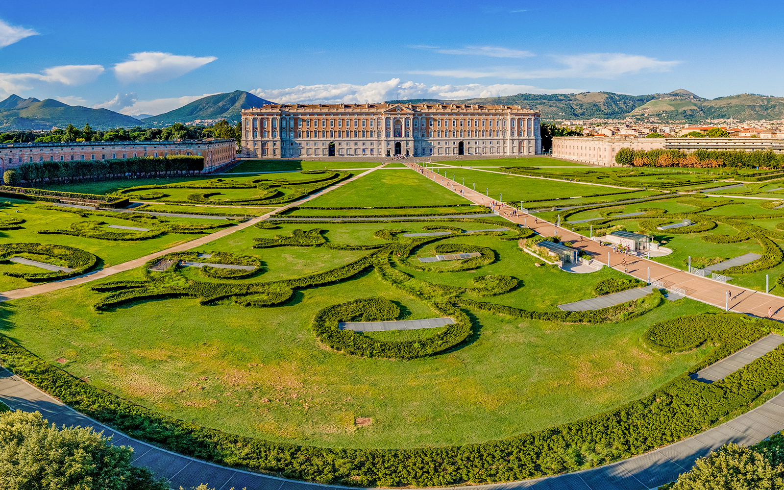 Royal Palace of Caserta with expansive gardens and intricate hedges in Caserta, Italy.