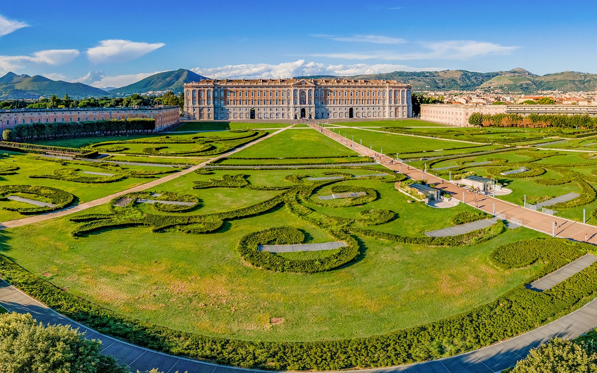 Royal Palace of Caserta with expansive gardens and intricate hedges in Caserta, Italy.