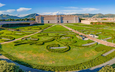 Royal Palace of Caserta with expansive gardens and intricate hedges in Caserta, Italy.