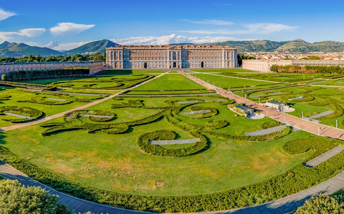 Royal Palace of Caserta with expansive gardens and intricate hedges in Caserta, Italy.