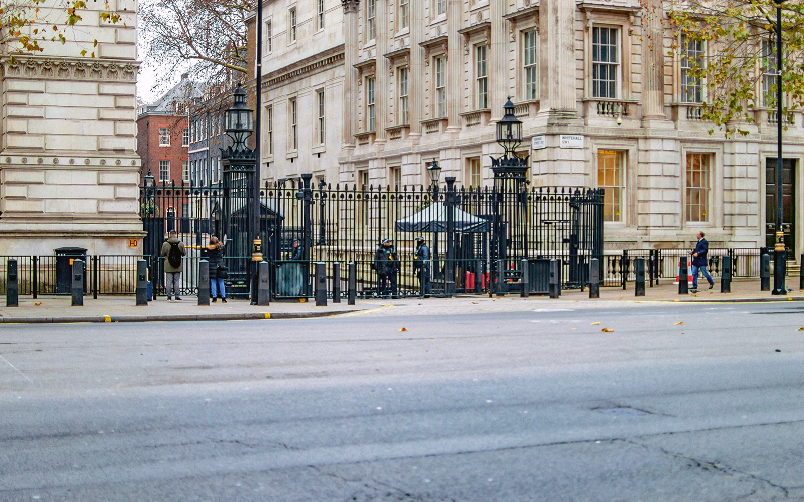Entrance to Downing Street, London, with security and historic buildings visible.
