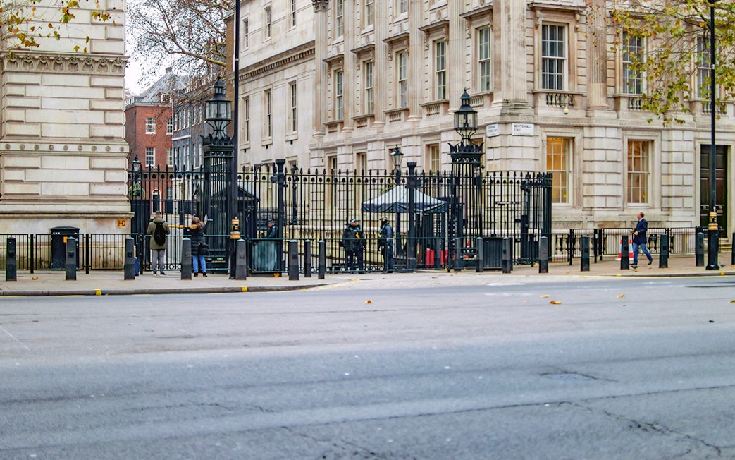 Entrance to Downing Street, London, with security and historic buildings visible.