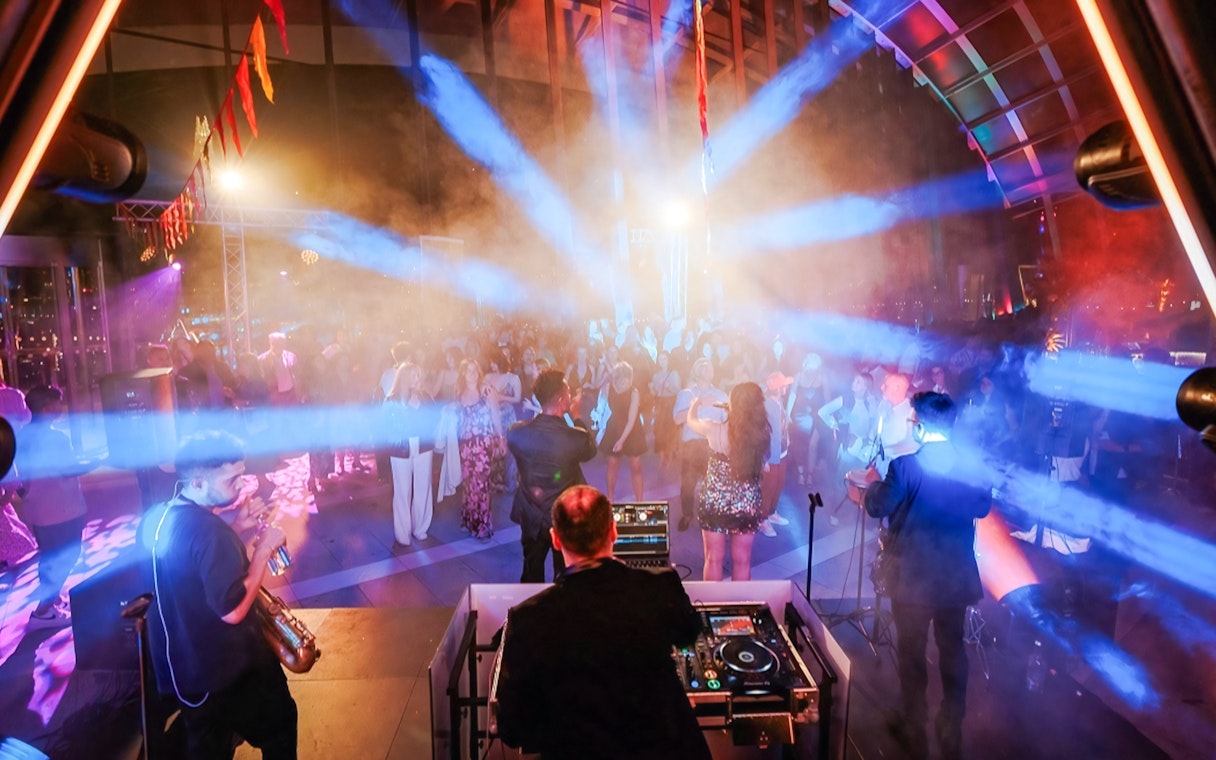 DJ and live band performing at Music Night, Sky Garden London, with a vibrant crowd.