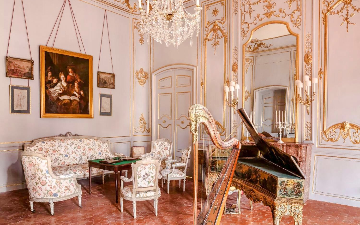 Elegant room with ornate decor, harp, and piano at Caumont Centre d’Art, Aix-en-Provence.
