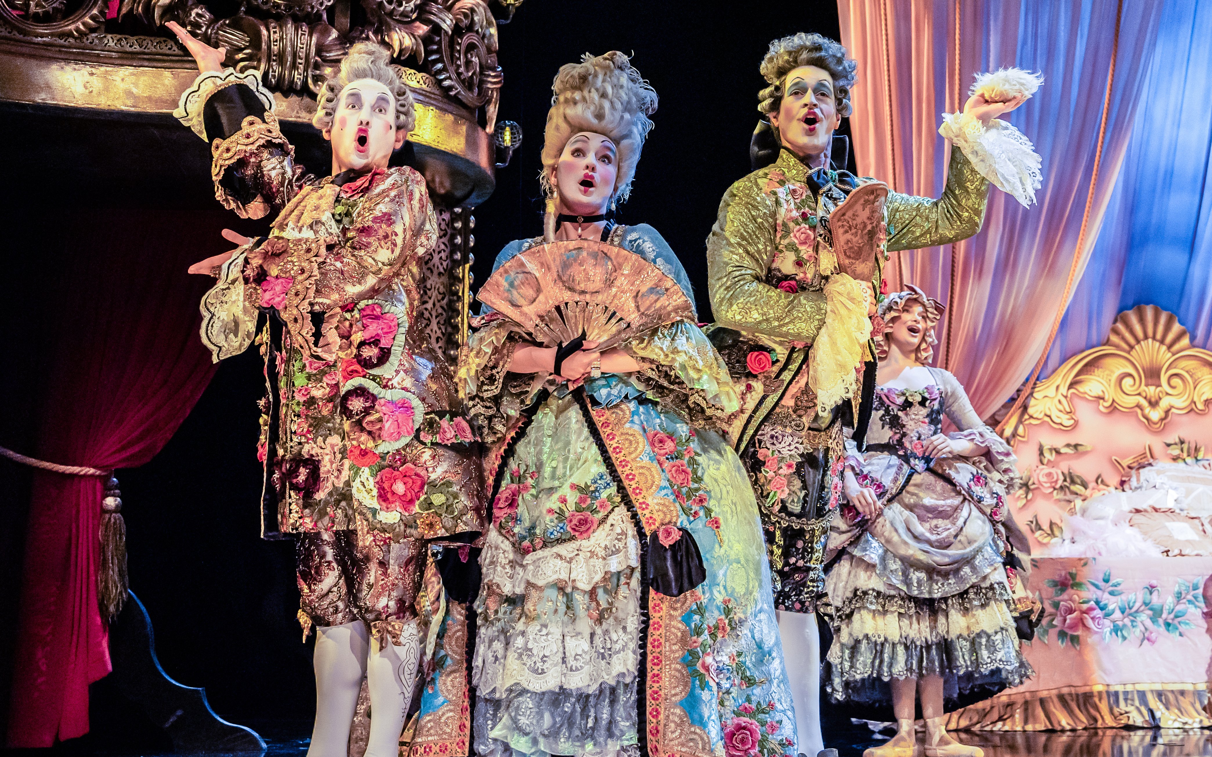 Performers in ornate costumes on stage during Phantom of the Opera production.