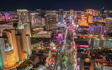 Las Vegas Strip illuminated at night from a helicopter view.
