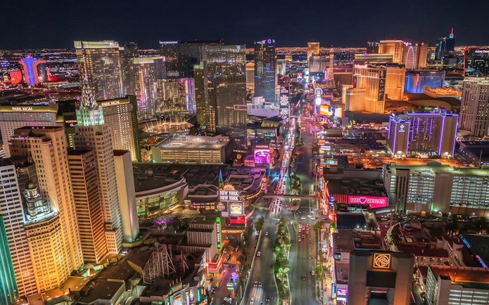 Las Vegas Strip illuminated at night from a helicopter view.